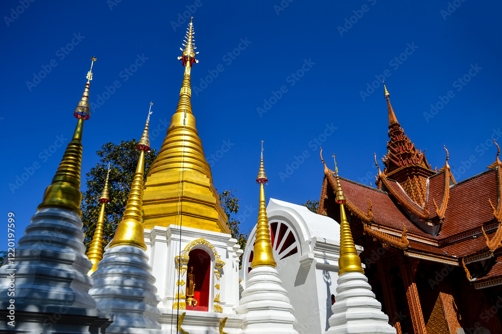 Fototapeta premium Chapel and Golden Pagoda, Lanna Architecture, Symbols of Buddhism, South East Asia at Doi Sapphanyu Temple, Mae Wang Chiangmai, Northern Thailand