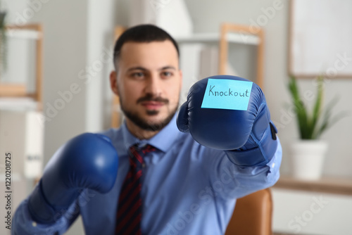Young businessman in boxing...