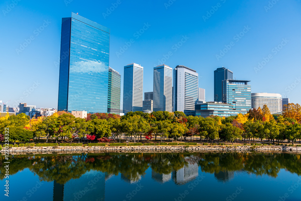 Autumn cityscape of Osaka city skyline with skyscraper building and autumn leaves tree nature park. Autumn cityscape of Osaka city skyline with skyscraper building and autumn leaves tree nature park.