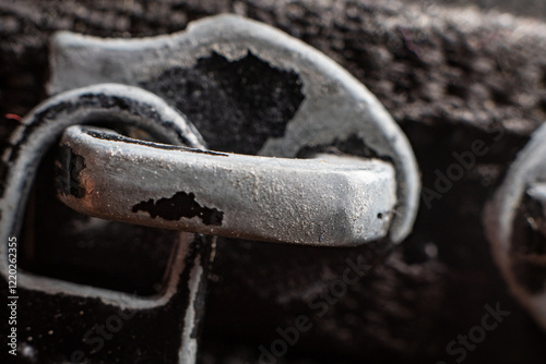 Rusty metal hook with detailed texture and dark background highlights nature of wear photo