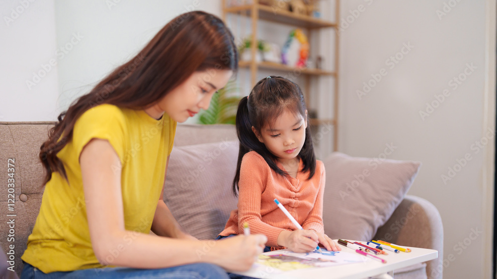 Fototapeta premium A mother assisting her daughter with homework at the table, surrounded by books and stationery, fostering learning and support.