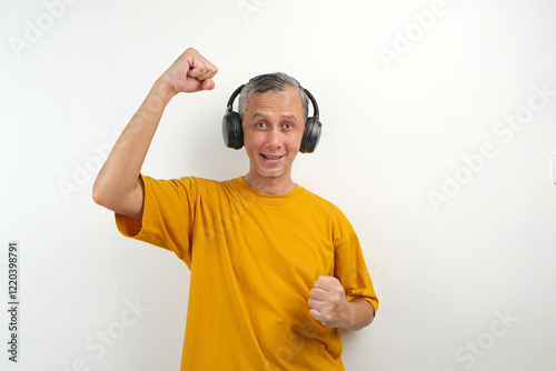 Adult Asian Man with headset clenched fist showing successful gesture
 photo