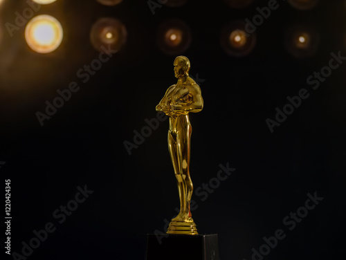Fotografie A golden Oscar statue stands on a black pedestal