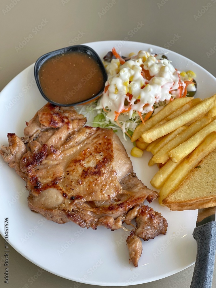 chicken steak and gravy with sausage, salad, French fries on white dish. chicken steak and gravy with sausage, salad, French fries on white dish.