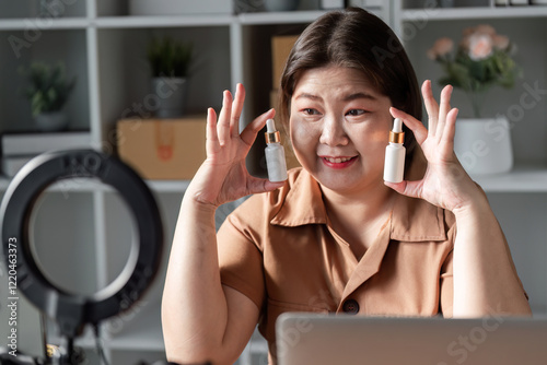 Young woman showcasing two skincare serums during a lively livestream, engaging with her beauty audience photo