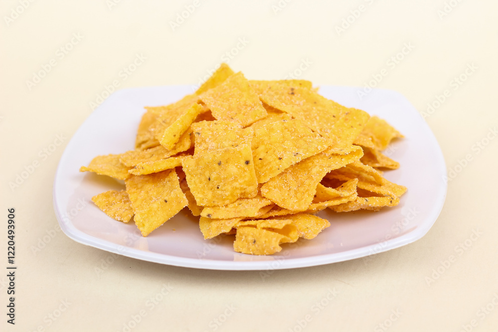 Close up of corn chips served in a plate and isolated on a white background. Close up of corn chips served in a plate and isolated on a white background.