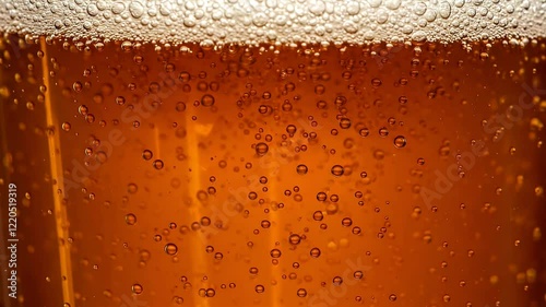 Close-up view of beer with moving bubbles occupying the whole screen