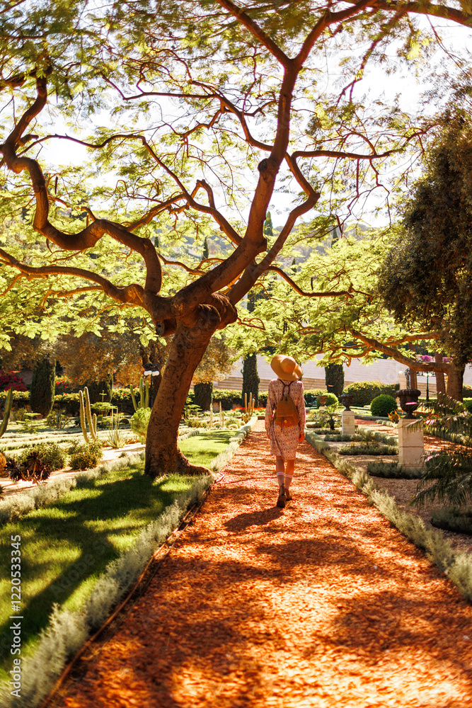 Obraz premium girl in motion expresses happiness in a city park. An attractive, cheerful woman feels free and joyful on a good day.