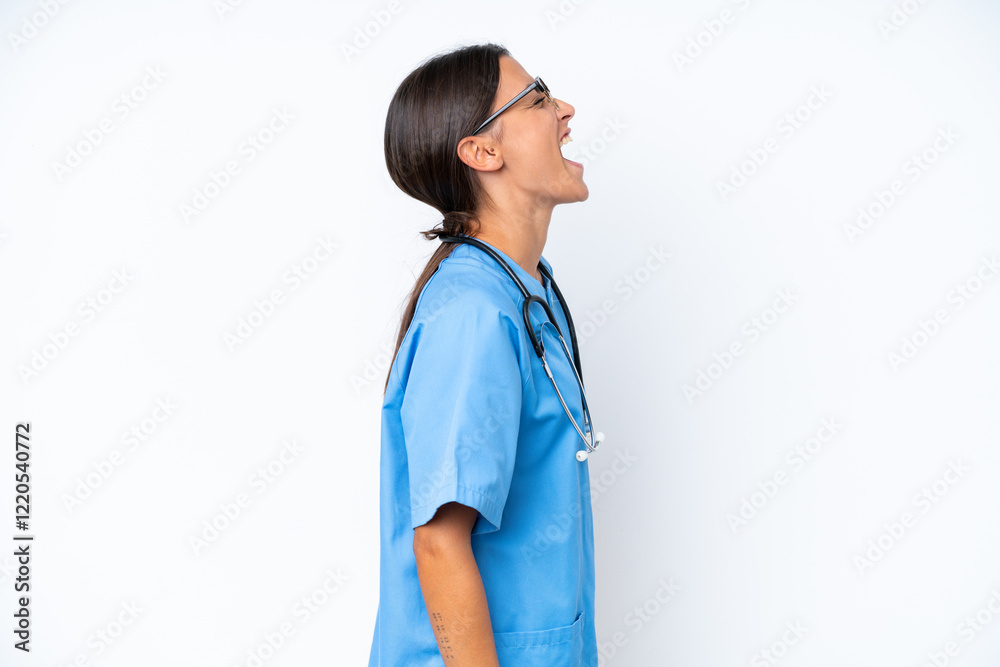 Young nurse woman isolated on white background laughing in lateral position Young nurse woman isolated on white background laughing in lateral position