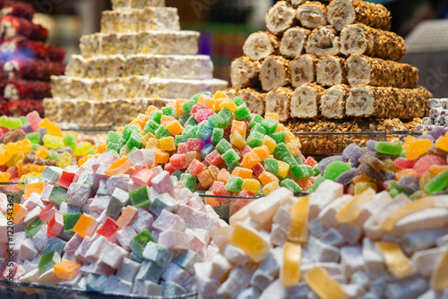 Vibrant assortment of Turkish delights, nougat, and nut rolls beautifully arranged in a shop, showcasing traditional sweets and flavors. photo