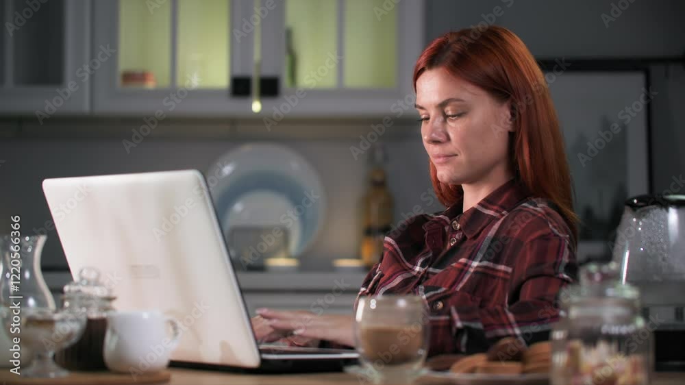 lunch snack, young woman working on laptop computer while snacking on cookies and coffee sitting at kitchen table