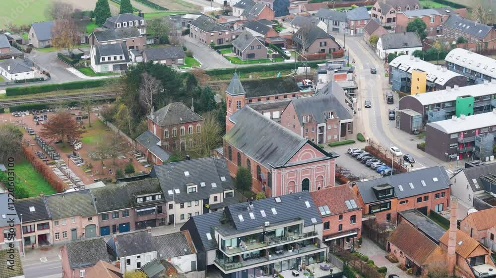 focuses schoonaarde's church village center belgium railway line residential apartments including street runs close up circling aerial drone shot view close-up focuses schoonaarde's church village center belgium railway line residential apartments including street runs close up circling aerial drone shot view close-up