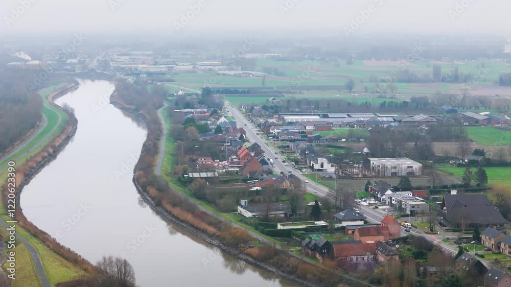 countryside village main road residential houses situated next to river scheldt rural setting aerial drone shot view scenic overview community layout countryside village main road residential houses situated next to river scheldt rural setting aerial drone shot view scenic overview community layout