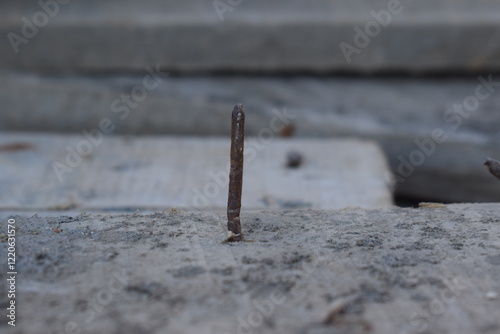 nail on wood Old rusty nail sticking out of the ground, Broken and defective new metal nail closeup. Bent damaged product. Reject expendable material.