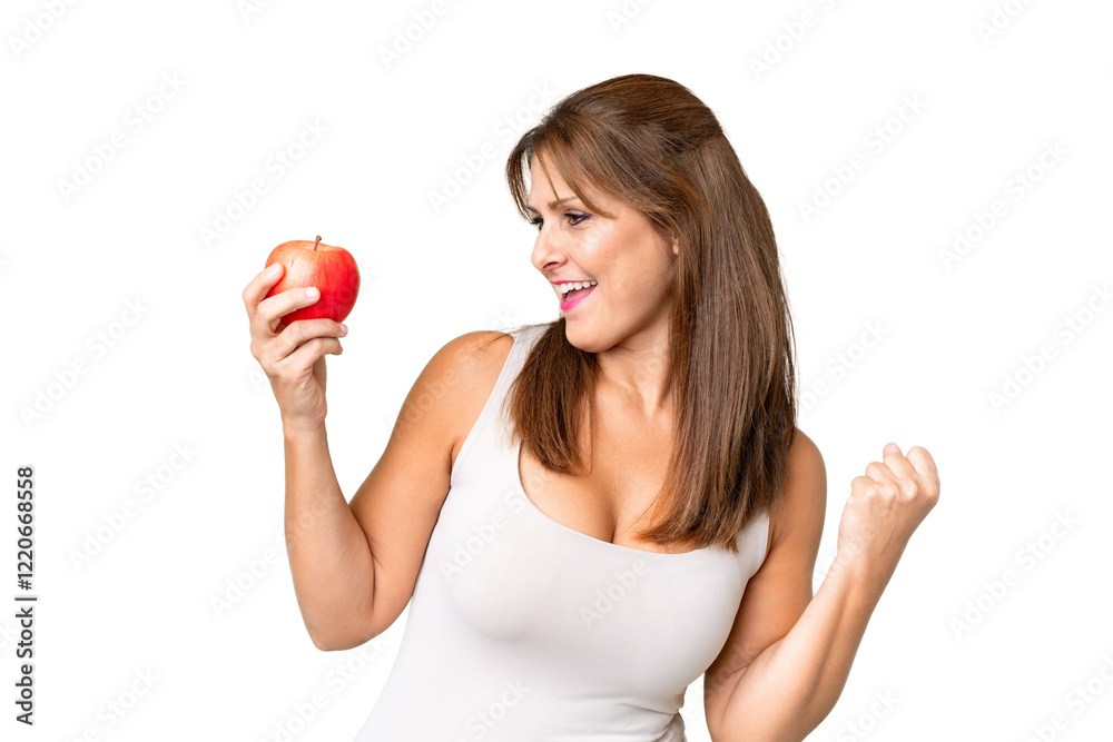 Middle age woman with an apple over isolated background celebrating a victory Middle age woman with an apple over isolated background celebrating a victory
