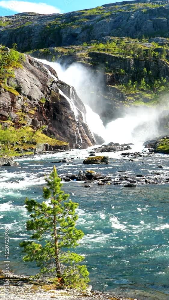 Kinsarvik, Hordaland, Norway. Waterfall Sotefossen In Hardangervidda Mountain Plateau. Famous Norwegian Landmark And Popular Destination In Spring Sunny Day. .