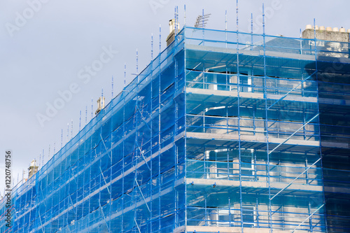 Scaffolding surrounding residential development for safe access to construction work