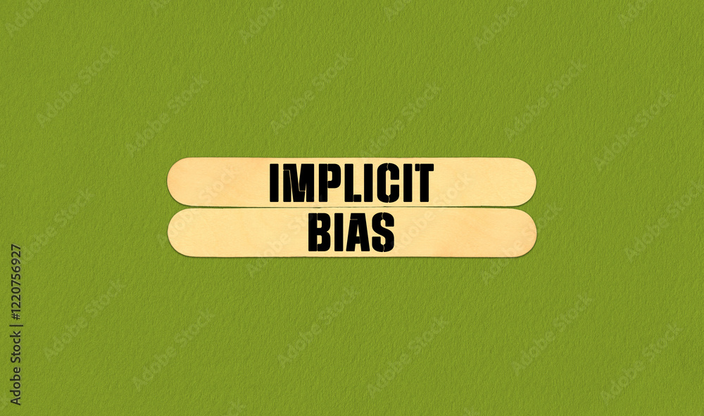 Fototapeta premium Implicit Bias Symbol. Concept word Implicit Bias on beautiful wooden stick. Beautiful Green Chart Paper Background. Business and Implicit Bias concept. Copy space