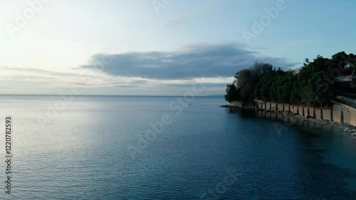 Wallpaper Mural Drone flying over serene water with fenced shore adorned with green trees Torontodigital.ca