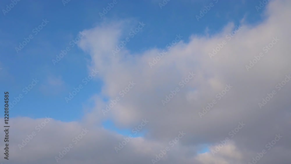 Beautiful blue sky with fluffy clouds during the day over a serene outdoor setting Beautiful blue sky with fluffy clouds during the day over a serene outdoor setting
