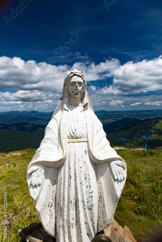 statue of maria on top of the mountaine