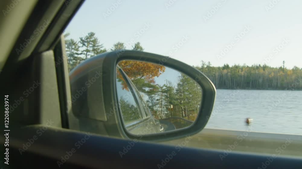 A Side Rearview Mirror Of A Blue Car Driving Through The Vast Countryside On The Highway. The Reflection Displays The Peaceful Beauty Of The Open Road Surrounded By Nature. A Side Rearview Mirror Of A Blue Car Driving Through The Vast Countryside On The Highway. The Reflection Displays The Peaceful Beauty Of The Open Road Surrounded By Nature.