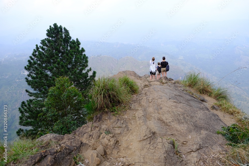Misty scenery of viewpoint Rock Ella in Sri Lanka with tree sitting girls on cliff. Misty scenery of viewpoint Rock Ella in Sri Lanka with tree sitting girls on cliff.