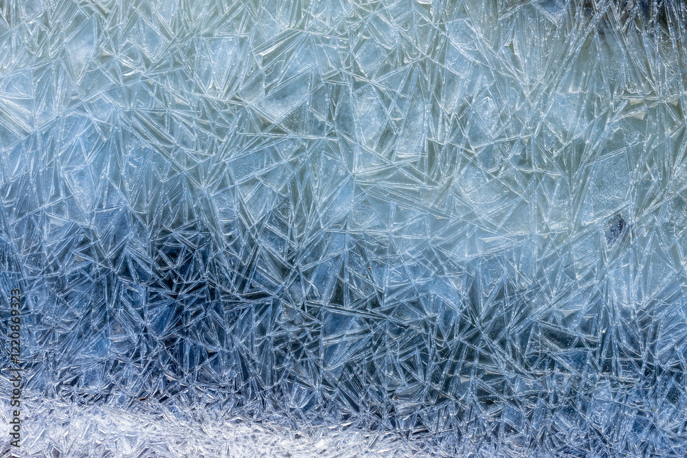 Frosty Pattern. Frost on a window with frozen ice crystal textures. Close-up photo showcasing the intricate frozen design. Abstract glacial art captured in a macro shot of delicate, multicolored ice. Frosty Pattern. Frost on a window with frozen ice crystal textures. Close-up photo showcasing the intricate frozen design. Abstract glacial art captured in a macro shot of delicate, multicolored ice.