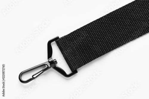 Black belt or strap with a snap fastener, for bags, backpacks and other items. Studio photo, close-up.