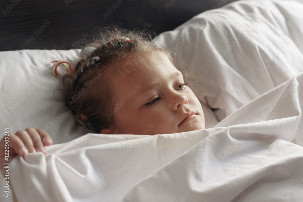 Obraz premium Portrait of cute adorable smiling little girl waking up in her bed