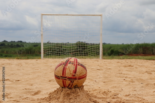 Sand field for beach soccer practice, with a ball positioned in front of the goal.