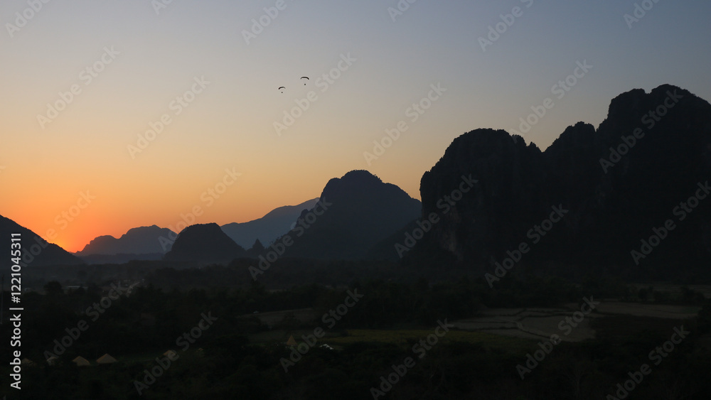 Bright lit evening sky over mountains at sunset, Vang Vieng, Laos. Bright lit evening sky over mountains at sunset, Vang Vieng, Laos.