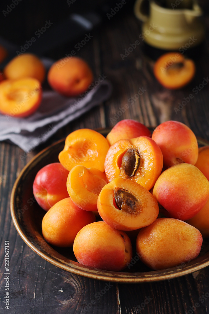 Fresh ripe apricots in bowl in rustic style Fresh ripe apricots in bowl in rustic style