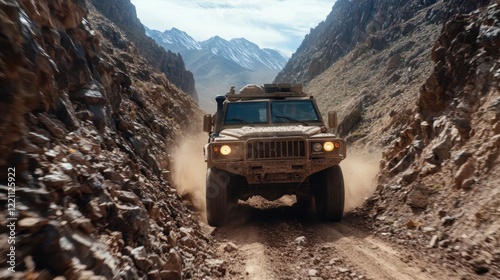 A military vehicle tackles a narrow mountain path, kicking up dust as it navigates through rocky terrain, showcasing strength and durability in challenging conditions.