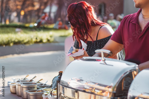 Woman makes hot dogs in competition for best hotdog. photo