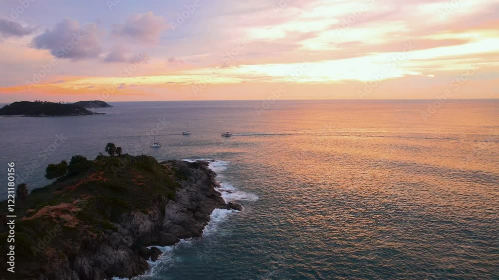 Boats sailing near promthep cape at sunset in phuket, thailand Boats sailing near promthep cape at sunset in phuket, thailand