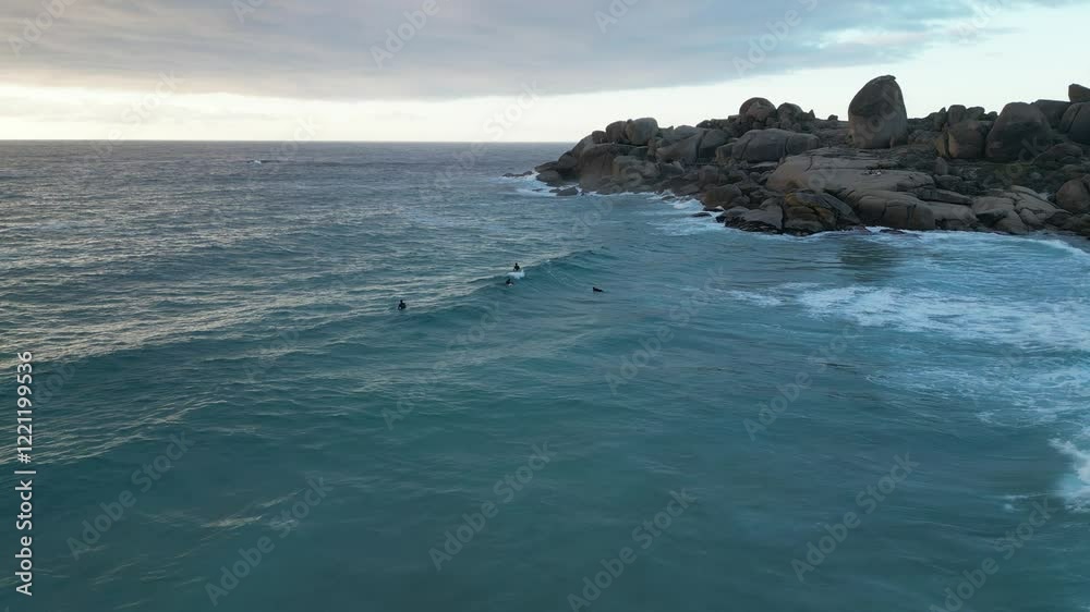 sea, surfers and rocks