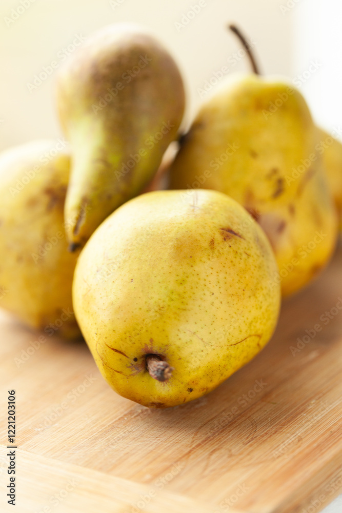 Ripe yellow pears on a wooden cutting board. Ready for a delicious recipe! Ripe yellow pears on a wooden cutting board. Ready for a delicious recipe!