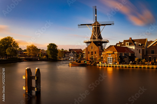 Windmill and traditional houses in Haarlem. Haarlem lies on the river Spaarne. Holland, Netherlands photo