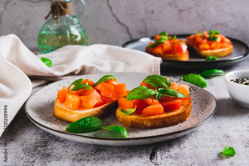 Appetizing bruschetta with tomatoes, garlic and basil on a plate on the table
