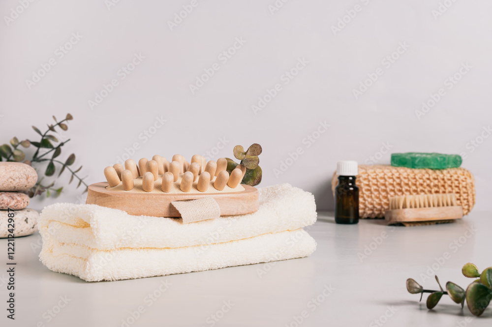 Natural organic body massager on towel and spa items on table