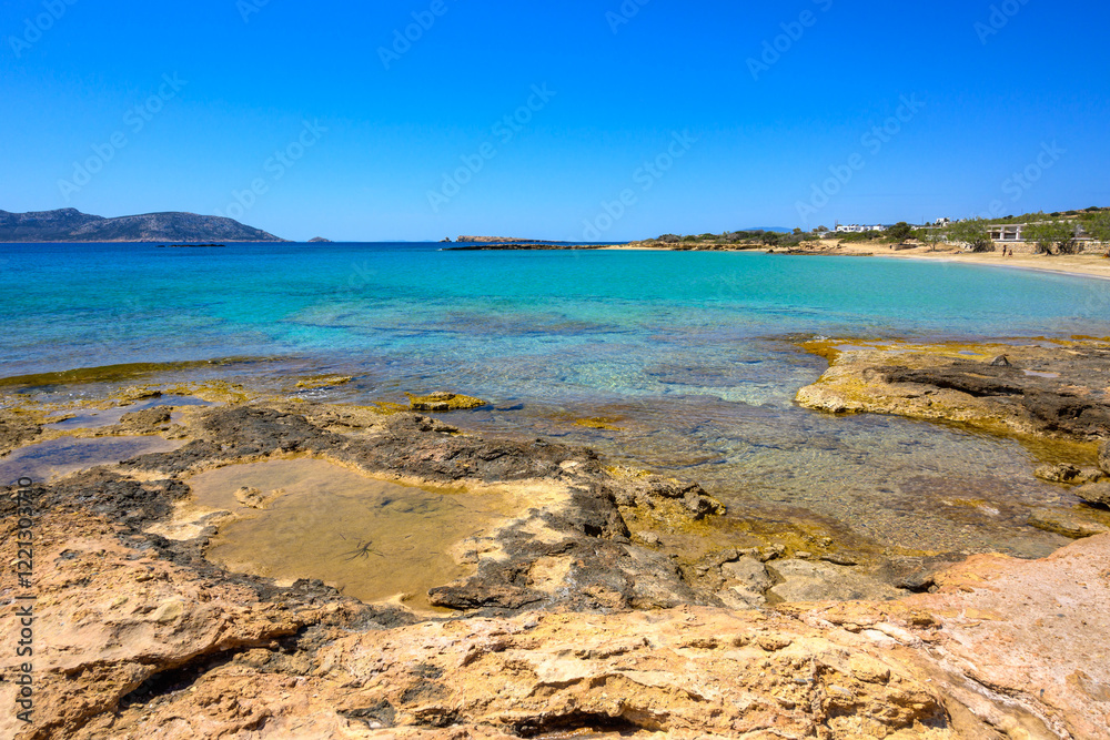 Ano Koufonisi beach with rocks and azure sea water. Small Cyclades, Greece