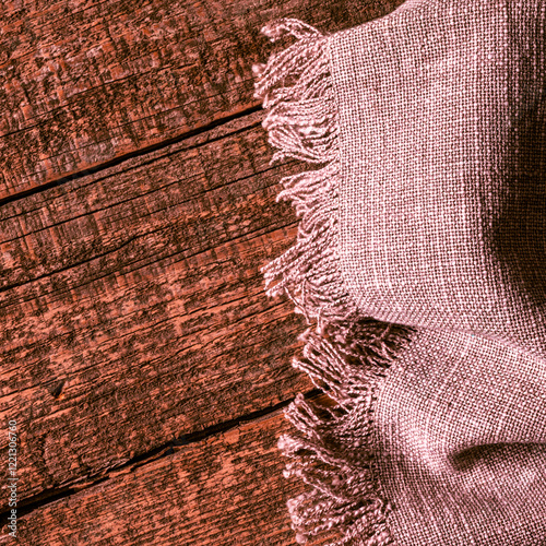 Linen woven napkin lies on an old wooden table