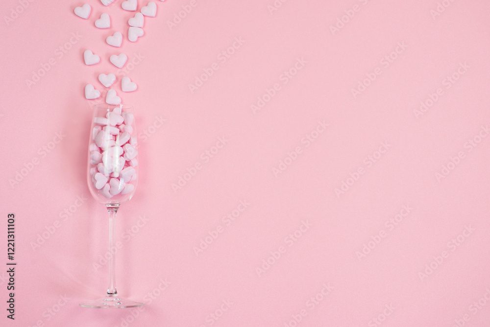 Glass with hearts on pink background, Valentine's Day, background with space for text Glass with hearts on pink background, Valentine's Day, background with space for text