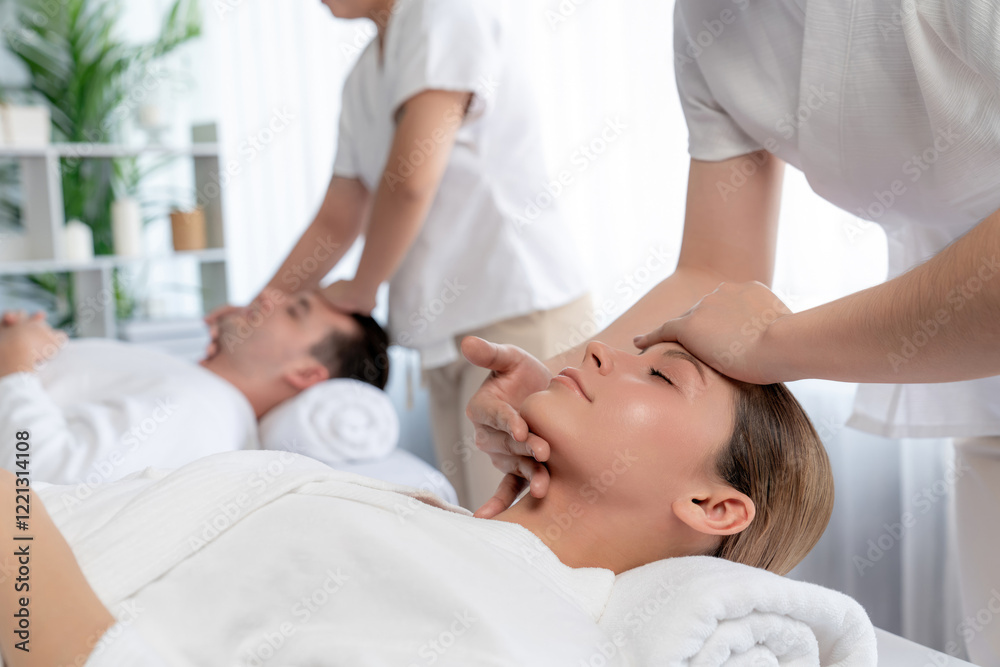 Obraz premium Caucasian couple enjoying relaxing anti-stress head massage and pampering facial beauty skin recreation leisure in dayspa modern light ambient at luxury resort or hotel spa salon. Quiescent