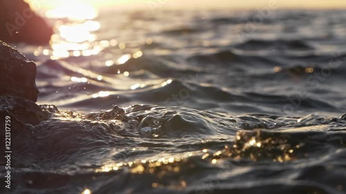 Rocky coastline at sunset waves, slow motion
