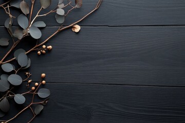 Elegant Eucalyptus and Gold on Dark Wood: A stylish arrangement of eucalyptus branches with golden accents on a dark wood background.