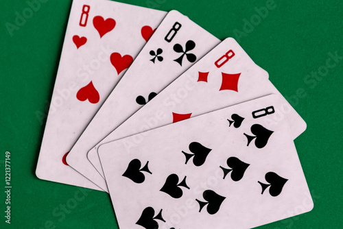 Poker quads playing card, green background photo