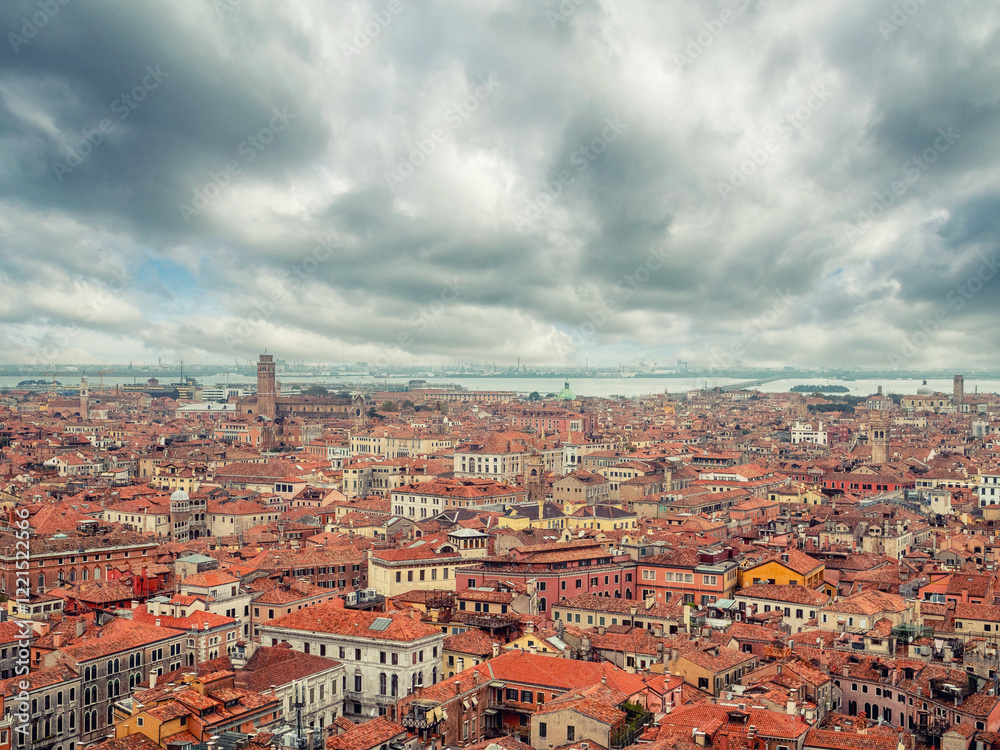 Naklejka premium A cityscape of Venezia, Italy, from a high view point. The sky is cloudy and the buildings are old and roof are with ceramic tiles. Travel and tourism.