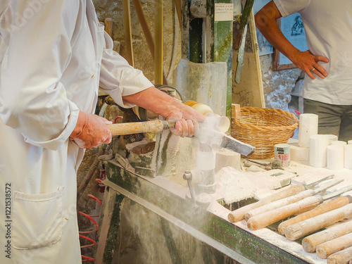 Tableau sur toile Sculptor and carver in work progress at a workshop of gypsum alabaster rock in Volterra, Italy, Tuscany